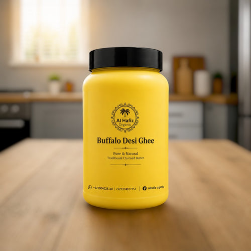 My Store 3 Al Hafiz Organic buffalo desi ghee in a yellow plastic jar on a wooden kitchen table.